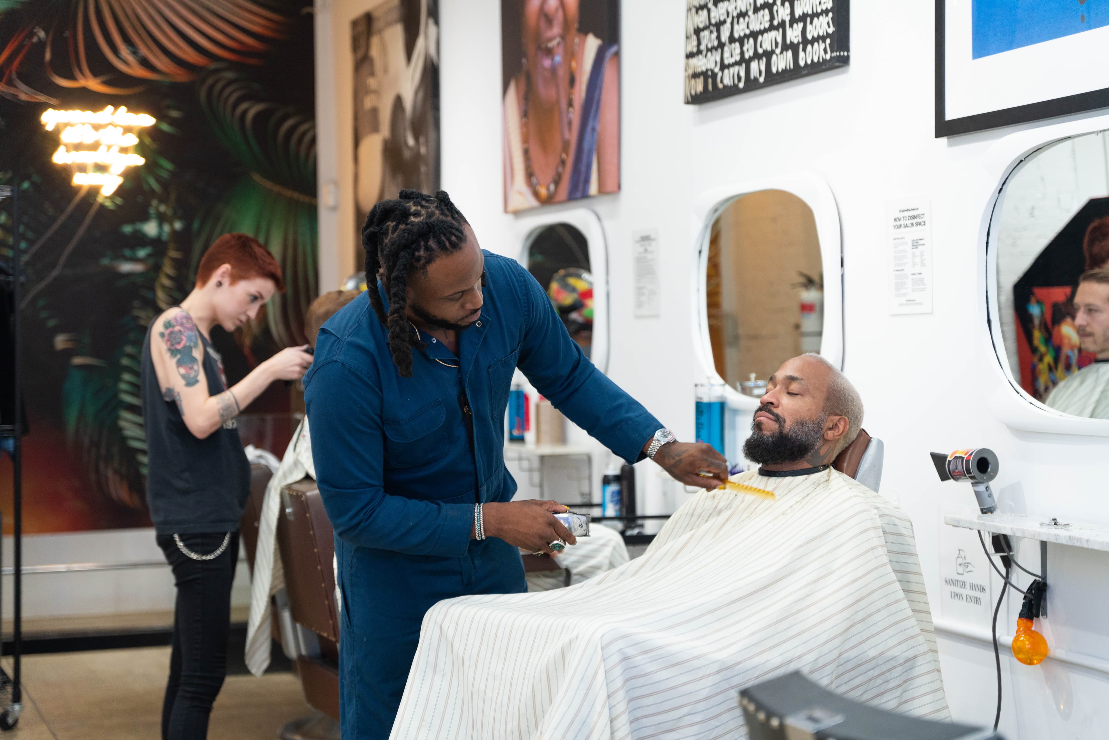 Barber working with a client inside the Lower East Side shop